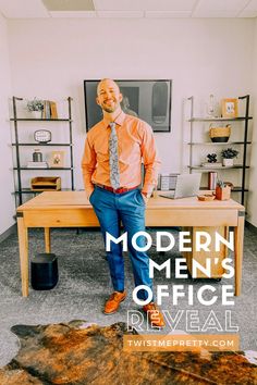 a man in an orange shirt and tie standing next to a desk with the words modern men's office reveal