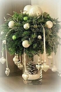 a vase filled with christmas decorations on top of a table