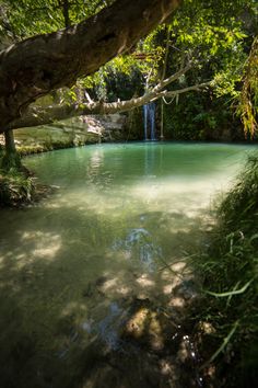 there is a small waterfall in the middle of this river and it's clear water