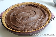 a chocolate pie sitting on top of a white table