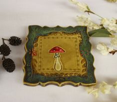 there is a decorative plate with a mushroom on it