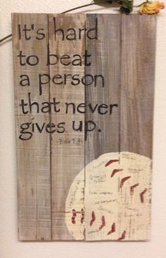 a wooden sign with a baseball on it that says, it's hard to beat a person that never gives up