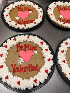 four decorated valentine's day cakes sitting on top of a table