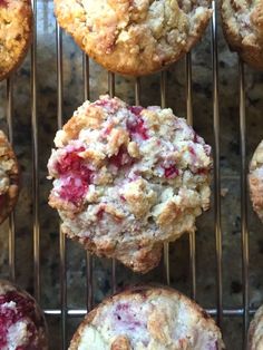 muffins cooling on a rack with cranberries and strawberries in them