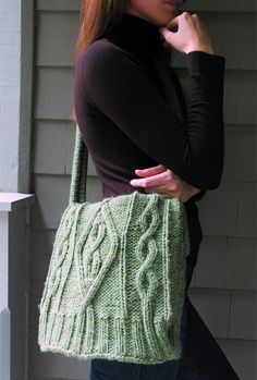 a woman carrying a green knitted bag