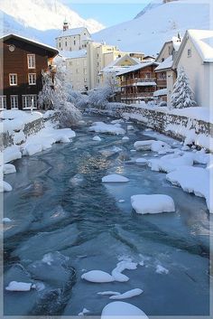 a river running through a snow covered town