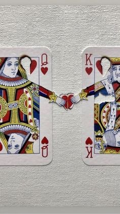 two playing cards that have been made to look like kings and queens holding hands with each other