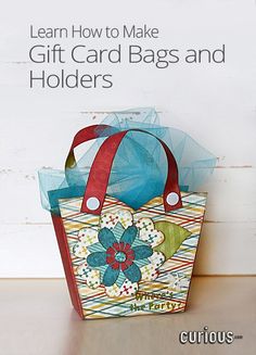 a small bag with a blue bow on it sitting on top of a wooden table