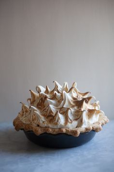 a pie sitting on top of a table covered in meringue and whipped cream