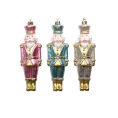 three colorful nutcrackers are standing next to each other