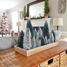 a living room decorated for christmas with pine trees in the center and other holiday decorations