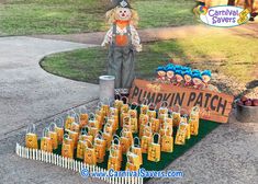 there is a scarecrow with many bags on the ground and a sign that says pumpkin patch