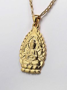 Beautiful Avalokiteshavara Kuan Yin Goddess Gold plated Pendant Necklace  ☆ Kuan Yin has been revered as the       Goddess of Compassion. ☆ She is one of the few feminine deities. ☆ Many women adore her and       feel empowered by her. ☆ Finely detailed Buddha charm     measures 35 mm tall by 20 mm wide     by 1 mm thick.    ☆ Includes a quality 2mm wide       Gold Plated Stainless steel       FIGARO chain       60 cm = 23.6 inches long       with lobster clasp making      this a beautiful pendant necklace. ☆ Eco-packaged in gift box and     reusable decorative gift bag. ☆ FREE USA SHIPPING!      Ships same day as ordered to USA only. ☆ Love and Compassionate      Peace to you & yours ! Spiritual Gold Necklace For Celebration, Spiritual Gold Jewelry For Gifts, Spiritual Gold Necklace Gift, Gold Spiritual Necklace For Gifts, Kuan Yin Goddess, Goddess Birthday, Goddess Of Compassion, Buddha Pendant Necklace, Beautiful Pendant Necklace