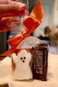 someone is holding a chocolate bar wrapped in cellophane with a ghost on it