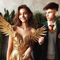 a young man and woman dressed in harry potter costumes standing next to each other with gold wings on their shoulders