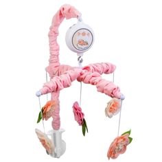 a pink and white baby crib mobile with flowers