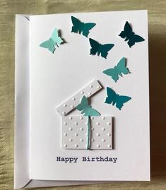 a birthday card with paper butterflies flying around it