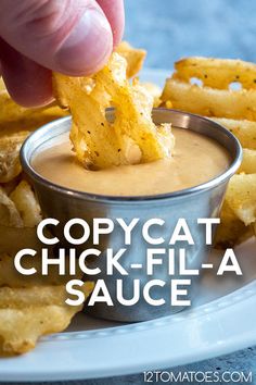 a hand dipping some food into a small bowl with sauce on it and the words copycat chick - fil - la sauce