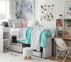 a bed room with a neatly made bed next to a desk and chair in front of a window