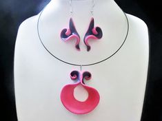 This pink purple Fimo (polymer clay) wavy, jewelry is sunny, artistic and standing out. With my special stretch and pull method I like to make this wavy shapes, I make a circel of Fimo pink up and purple down. The necklaces are made of half a circel. The earrings from a 1/4 circel. The earrings can hang or fit on the ear with studs or clips. See for necklace only: https://www.etsy.com/listing/593167738/purple-pink-necklace-pendant-on-black?ref=listings_manager_table  for earrings only: https://www.etsy.com/listing/697362528/pink-and-purple-swirly-triangle-ear?ref=listings_manager_table Fimo is light and strong and still a bit flexible, it wears very comfortable. This particular necklace is striking and eccentric. Together with the earrings you will be splendid. Pink Hand-painted Polymer Clay Jewelry, Hand Painted Pink Polymer Clay Jewelry, Earrings Fimo, Pendant With Earrings, Pink Pendant, Fimo Polymer Clay, Rose Violette, Chic Necklace, Choker Pendant