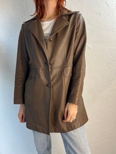 "- Vintage Marquis brown leather half trench jacket - Satin lining - Made in Canada - A few scuffs on the leather shell - No size tags  Chest: 20\" Waist: 18\" Length: 30\"" Vintage Leather Outerwear For Spring, Vintage Leather Outerwear For Fall, Vintage Long Leather Jacket For Fall, Fitted Vintage Brown Outerwear For Fall, Vintage Brown Outerwear For Work, Retro Brown Outerwear With Snap Buttons, Brown Leather Spring Outerwear, Brown Long Coat With Snap Buttons, Retro Vintage Brown Outerwear For Work