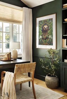 an office with green walls and white drapes on the windowsills, a wooden chair in front of a desk that has a potted plant next to it