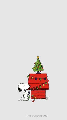 a charlie brown christmas tree on top of a red house with a snoop bear sitting next to it