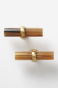 two brass and wood handles on white background