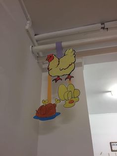 there is a cartoon chicken hanging on the wall