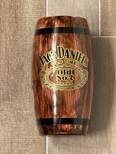 an old no 3 jack daniels whiskey bottle mounted on a wall with tile flooring