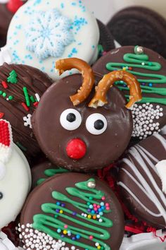 chocolate covered cookies decorated like reindeers and snowflakes are in a white bowl