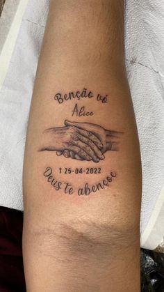 a tattoo on the leg of a person with two hands holding each other's hand