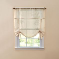 a window with a white curtain hanging from it's side