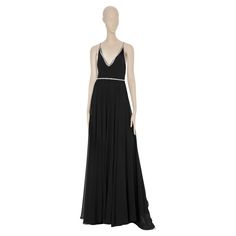 This exquisitely crafted Saint Laurent black evening gown features shimmering crystals and is sure to catch all eyes at your next special event. The delicate crystal details will leave a lasting impression of classic and timeless sophistication. Brand: Saint Laurent Product: Evening Gown With Crystal Details Size: 38 FR Colour: Black Material 100% Silk Condition: Pristine; Never Worn Details - V-Neck - Back Zip - Lining: 100% Silk Accompanied By: Dress & Tag Saint Laurent Dress, Black Evening Gown, All Eyes, All About Eyes, Evening Gown, Special Event, Evening Dress, Day Dresses, Evening Gowns