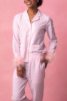 Experience comfort and style with our Camille Pajamas with Feathers. Made of white fabric with pink gingham accents, this set features a v neckline with a darling collar, functional buttons, and pockets for convenience. The long-sleeved top and wide-leg pants provide a perfect fit with an elastic waistband. Enjoy a night of peaceful slumber in these luxurious pajamas. Luxurious Pajamas, Luxury Pajamas, Night Set, Peaceful Night, City Woman, Pink Feathers, Pink Gingham, Sleepwear Sets, Sleepwear & Loungewear