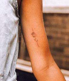 a person with a small tattoo on their arm