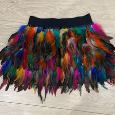 Feather Rainbow Skirt Mini From Red Dress Boutique. New . Never Worn. Size Xs. Spring Mini Skirt With Feather Trim, Spring Mini Skirt With Feathers, Fall Festival Mini Skirt, Spring Fitted Feather Skirt, Multicolor Winter Skirt, Summer Mini Skirt With Feathers, Feathered Mini Skirt For Summer, Bohemian Fall Party Skirt, Fitted Multicolor Skirt For Fall