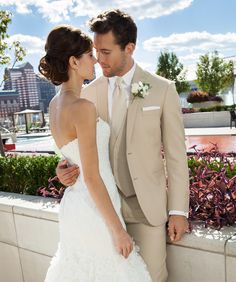 a bride and groom posing for a wedding photo