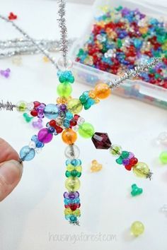 someone is making a beaded star ornament out of beads