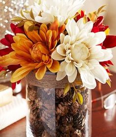 a vase filled with flowers on top of a wooden table