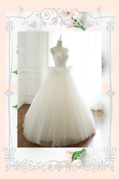 a white wedding dress on display in front of a window