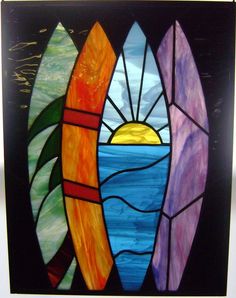 a stained glass window with three surfboards in the sun and water on it's side