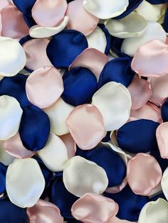 blue, pink and white petals are scattered on top of each other