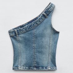 the back of a jean skirt with an open shoulder and straps on it, against a white background