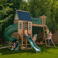 children playing in a backyard with a green slide