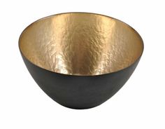 a black and gold bowl on a white background with the bottom half painted in metallic