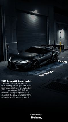 a black sports car parked in front of a garage with the words toyota on it