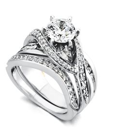 a white gold wedding ring set with two bands and a round diamond in the center