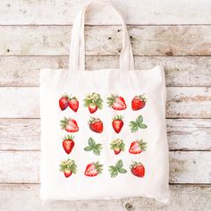 "Personalized Strawberry Tote Bag Strawberry Lover Gift Cute Grocery Tote Cute Farmers Market Bag Gift for Her Eco Friendly Reusable Grocery Bag Produce strawberry, strawberry gift, summer tote bag, summer bag, spring tote bag, spring bag, strawberry bag, strawberry lover, farmers market bag, book bag, reusable bag, eco friendly tote, school tote, Everyday Bag, Shoulder Bag, Canvas Tote, Cute Tote Bag, School Bag, book tote bag, school tote bag, aesthetic tote bag, reusable grocery bag, library bag, aesthetic tote, campus bag, campus tote bag Strawberry Bliss Eco-Friendly Tote Bag - the perfect companion for your sustainable shopping journey! Say goodbye to single-use plastic bags and embrace eco-conscious living with this charming and practical tote. Make a positive impact on the planet b Strawberry Tote Bag, Spring Tote Bag, Strawberry Bag, Spring Tote, Strawberry Gifts, Tote Bags For School, School Tote, Library Bag, Summer Tote Bags