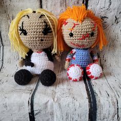 two crocheted dolls sitting next to each other